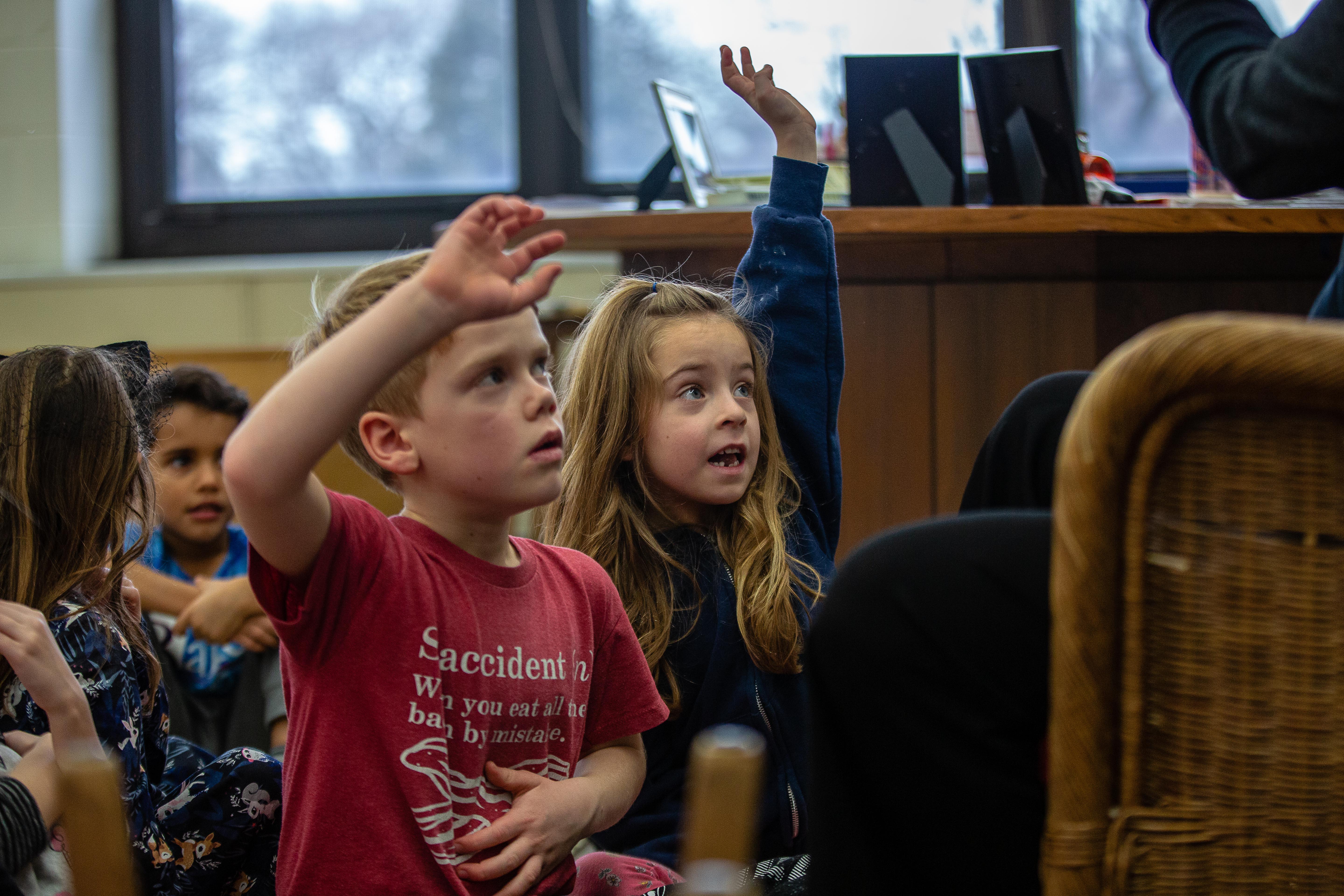 Primary students participating in class discussion