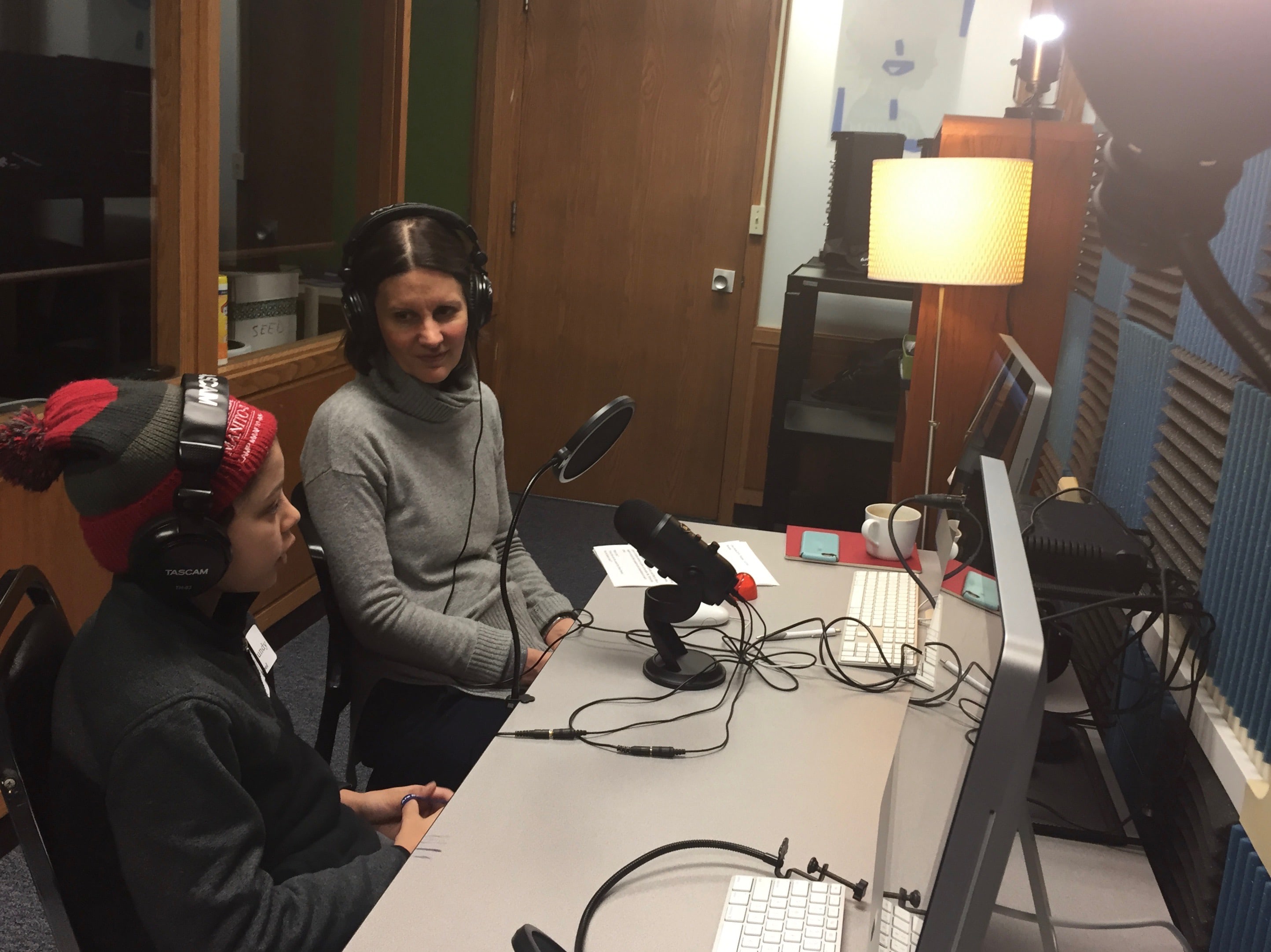 Middle School student and Head of School creating a podcast in the Media Center