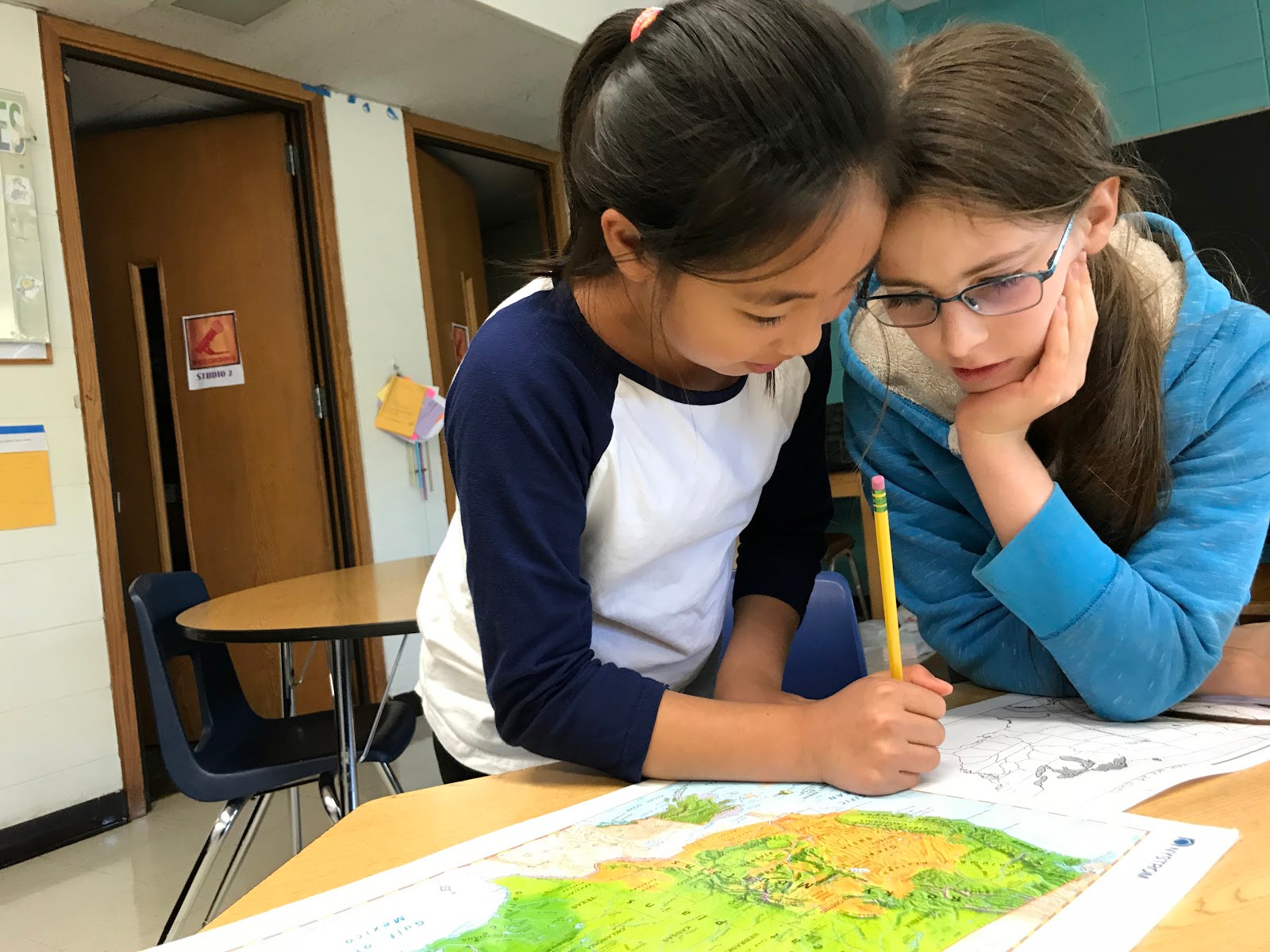 Intermediate students collaborating in project-based learning