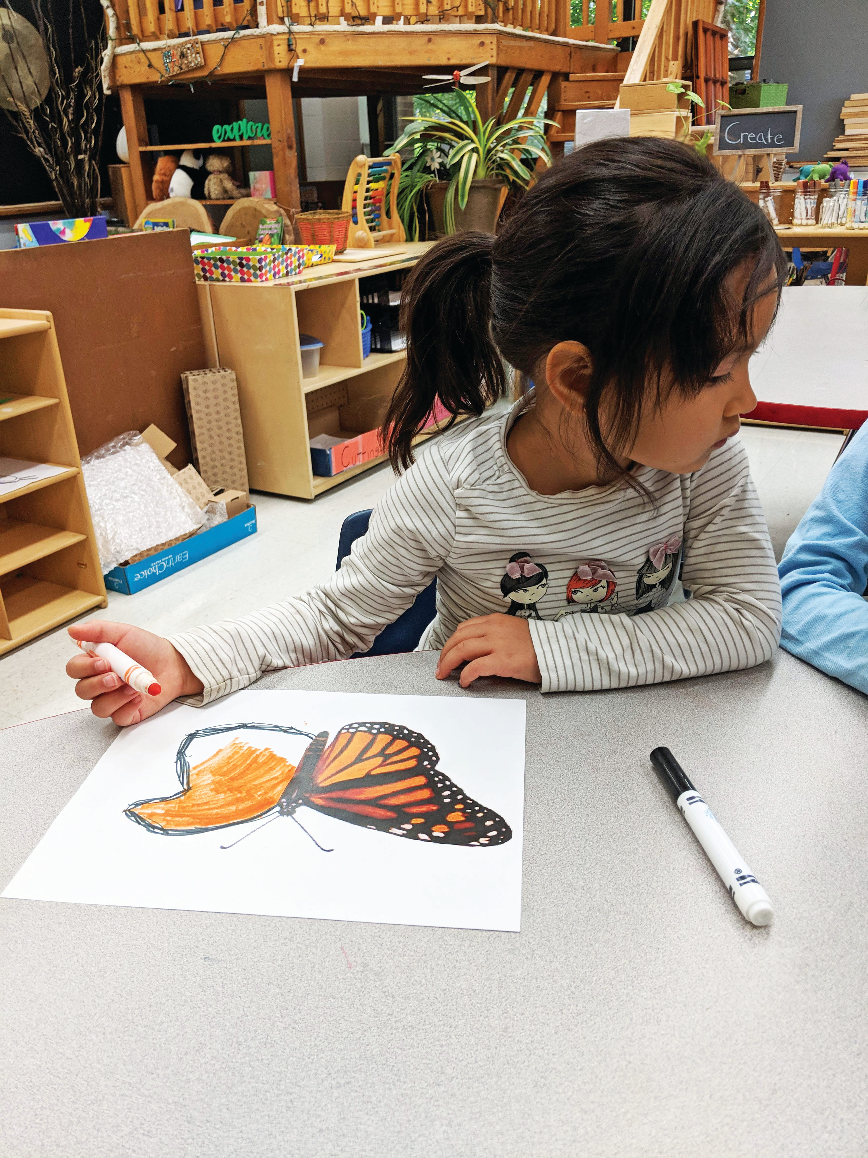 Early Childhood student creating art in Kindergarten class