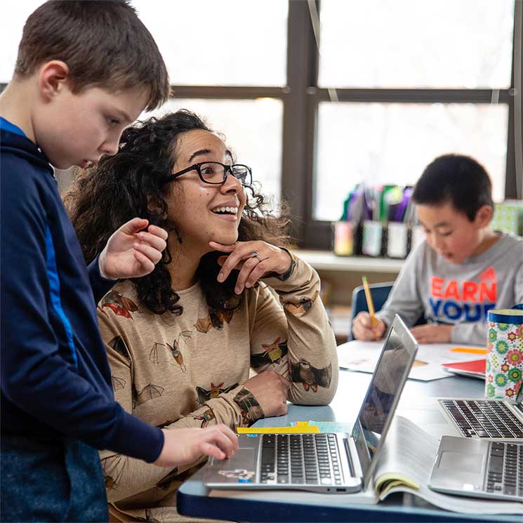 intermediate-teacher-student-laptop Teacher providing individual instruction to student